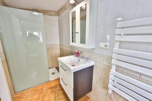 a bathroom with a sink and a shower at A Casa de Isaura in Camariñas +35 photos