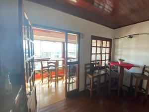 a dining room with a table and chairs and a window at Hotel rios rua uruguai n 99 in Jaguarão