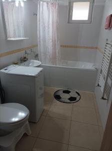 a bathroom with a toilet and a tub and a sink at Apartament Alex in Alba Iulia