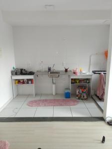 uma cozinha com um lavatório e um piso branco em Aconchego Hostel no Rio de Janeiro