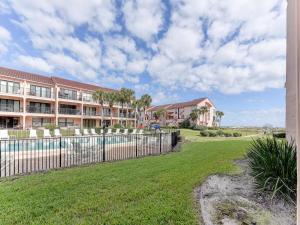 a fence in front of a building with a yard at Sea Place 14164, 3 Bedrooms, Sleeps 8, Ground Floor, Pool, Tennis, WiFi in St. Augustine
