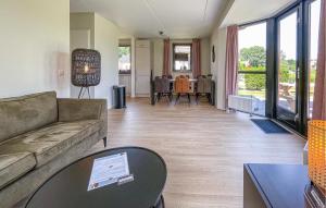 een woonkamer met een bank en een tafel bij Nice Home In Ewijk With 3 Bedrooms And Wifi in Ewijk