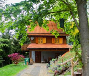 a house with an orange tiled roof and a driveway at Ferienhaus Sonnenblick Entspannung mit Sauna Kamin und Balkon in Sonneberg