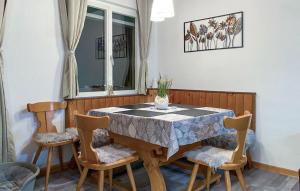 a dining room with a table and four chairs at Amazing Home In Friedberg With Kitchen 