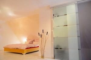 a bedroom with a bed and a glass wall at Ferienhaus Sonnenblick Entspannung mit Sauna Kamin und Balkon in Sonneberg