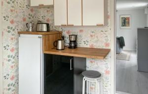 a small kitchen with a counter and a stool at Stunning Home In Sollebrunn With Kitchen in Sollebrunn