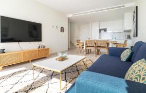 a living room with a blue couch and a tv at 3 Bedroom Amazing Apartment In Estepona in Estepona