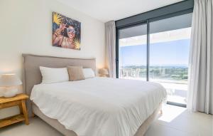 a bedroom with a bed and a large window at 3 Bedroom Amazing Apartment In Estepona in Estepona