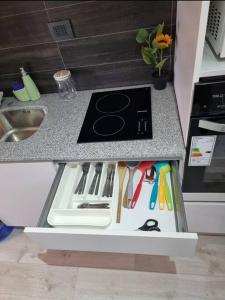 a kitchen counter with a drawer with utensils on it at Hermoso y cómodo departamento in Santiago