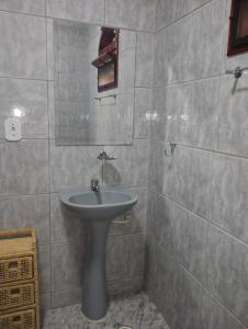 a bathroom with a sink and a mirror at Pouso Zen in Araruama