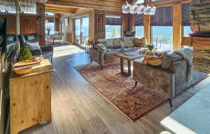 a living room with two couches and a table at Gorgeous Home In Passebekk With Kitchen in Omholt