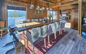 a dining room with a wooden table and chairs at Gorgeous Home In Passebekk With Kitchen in Omholt