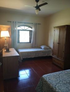 a hotel room with two beds and a window at Pouso Zen in Araruama +57 photos