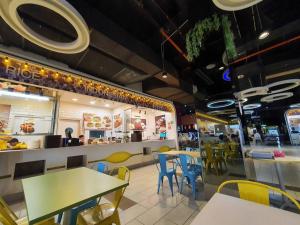 a fast food restaurant with tables and chairs at Vivacity Jazz 1 Luxury Cozy Home 8paxs Card LV 12 in Kuching