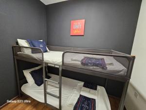 a room with three bunk beds in a room at Vivacity Jazz 1 Luxury Cozy Home 8paxs Card LV 12 in Kuching