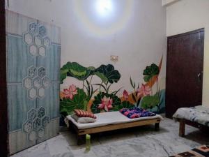 a room with a mural on the wall at Shri Homes in Varanasi