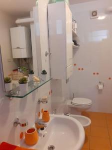 a white bathroom with a sink and a toilet at Greatly located/parking/balcony/2 bathrooms in Zagreb