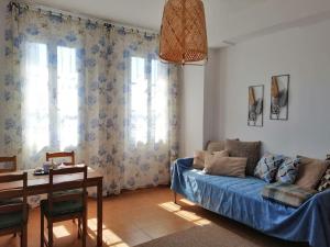 a living room with a couch and a table at Aegina Port Apt 2-Διαμέρισμα στο λιμάνι της Αίγινας 2 in Aegina Town
