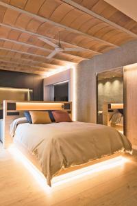 a bedroom with a large bed with a wooden ceiling at HomeSuiteHome Córdoba in Córdoba