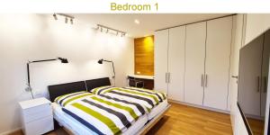 a bedroom with a bed with yellow and white stripes at Dein Chill-Space mitten in Hannover in Hannover