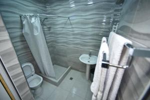 a bathroom with a shower and a toilet and a sink at MBM Hotel Yerevan in Yerevan