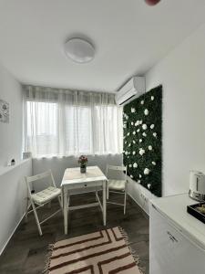 a kitchen with a table and chairs in a room at Love Light Studio Victoriei in Bucharest