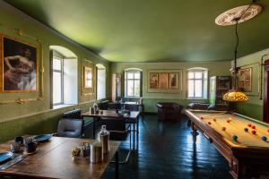 a dining room with a pool table and a room with ahibition at Villa Hänsch Suite 2 in Großschönau