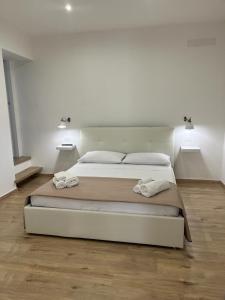 a bedroom with a large bed with two towels on it at VILLA ASTORE in Ruffano