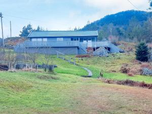 a house on top of a grassy hill with a house at 7 person holiday home in SANDNES-By Traum in Forsand
