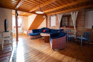 a living room with blue couches and a table at Zázrivský dvor in Zázrivá