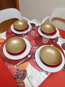 a table with plates and glasses on a red table at A Parada do Camiño in Padrón