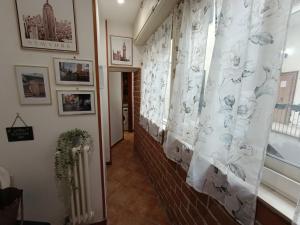 波佐利的住宿－Napoleon，走廊上设有砖墙、窗帘和窗户