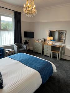 a hotel room with a bed and a desk at Birkdale Guest House in Shanklin