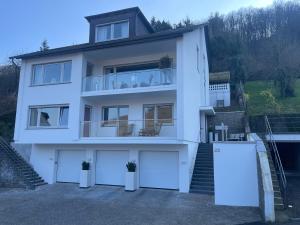 a white house with two garage doors at Gästehaus Paulina in Cochem