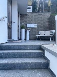 a set of stairs in front of a building with a bench at Gästehaus Paulina in Cochem