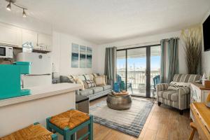 a kitchen and living room with a couch and a table at Tipsea on the seawall in Galveston