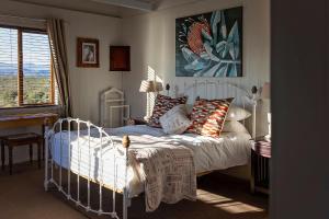 a bedroom with a white bed and a window at Drecaso in Bonnievale +50 photos