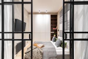 ソポトにあるLion Apartments - New Sopot by the sea!のベッドとテレビのある部屋