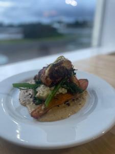 a white plate with food on a table at Bunessan Inn in Bunessan