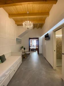 a living room with a couch and a chandelier at Atrium in Castellammare del Golfo