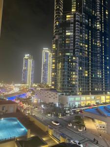 a view of a city at night with tall buildings at ROYAL BEACH RESIDENCES 2 in Dubai