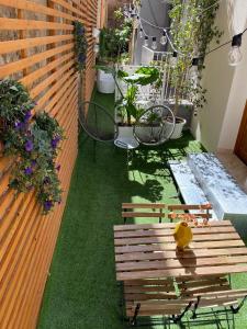 a patio with a bench and a table and chairs at Atrium in Castellammare del Golfo