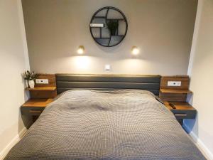 a bedroom with a bed and a mirror on the wall at Haus Seeschwalbe Borkum in Borkum