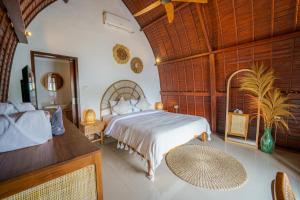 a bedroom with a large bed in a room at Shortcut Breeze Guest House in Canggu