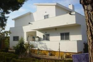 a white building with a tree in front of it at Villa Alma in Bari