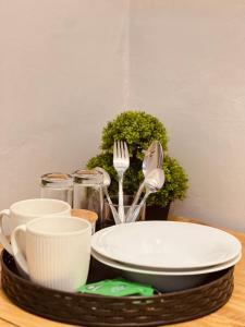 a tray with dishes and utensils on a table at De Bali à Conaky *KIPE* in Conakry