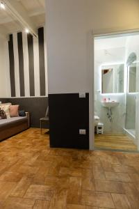 a living room with a couch and a sink at Santa Croce Dream Suites in Florence