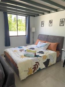 a large bed in a room with a large window at Homestay Studio TOKAYOH in Kota Bharu