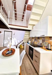 a kitchen with a white counter and a table at Casa con terrazza esclusiva vicino al mare Domus Neapolis Happy Holiday in Naples