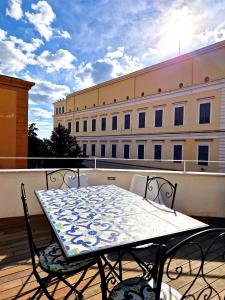 a table and chairs on a balcony with a building at Domus Neapolis Happy Holiday in Naples +32 photos